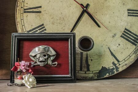 Picture frames skull and the clock on the old woodenの写真素材