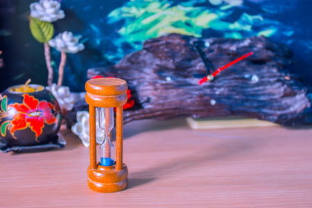 Hourglass in vintage style on woodの写真素材
