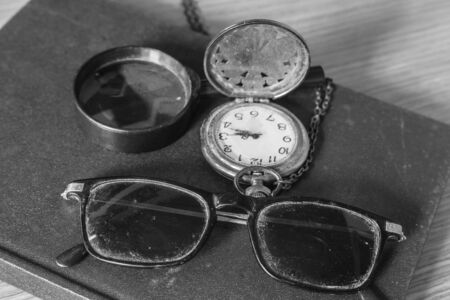 Glasses of dust and the old clock on the books.