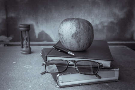 Glasses on the book's old desk.の写真素材