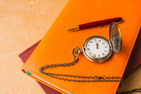 Stopwatch and pen on books