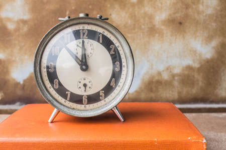 The old clock on the bookの写真素材