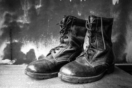 Boots shoe on old wooden table.の写真素材
