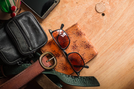 Leather accessories and bags on the woodenの写真素材