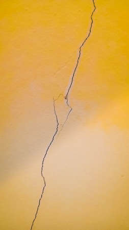 Yellow walls and cracks of the surface.の写真素材