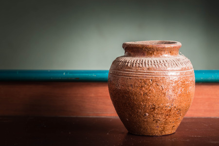 jar that sits on a wooden table.の写真素材