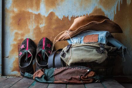 Leather bags and accessories to dress up in old wooden basket.の写真素材