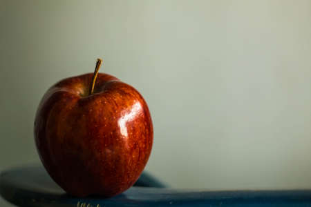 red apple on a green background.の写真素材