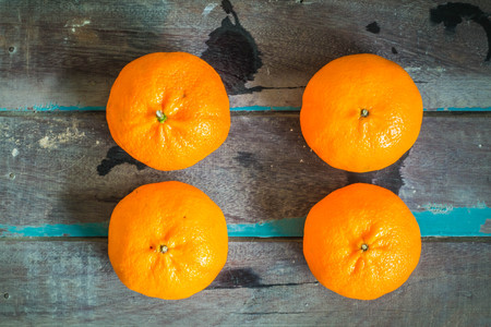Orange on a wooden board.