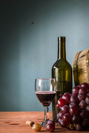 Red wine grapes on a wooden table in fermentation.の写真素材