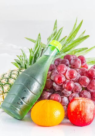 Juices and many fruits on a white background.の写真素材