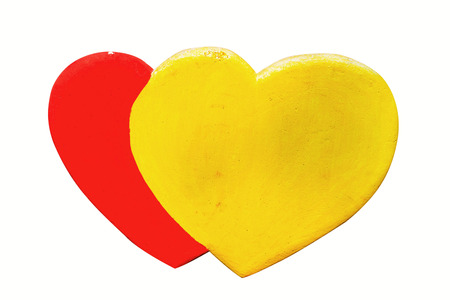 Yellow and red heart made of foam on a white background.の写真素材