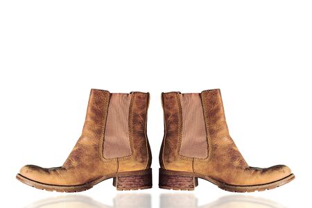Old leather boots on a white background.の写真素材