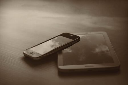 Mobile phones and tablets on a black background.の写真素材