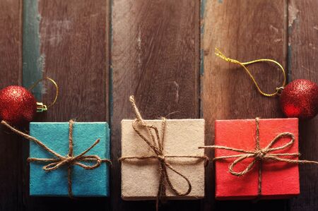 Gift box with multicolored on the old wooden floor.