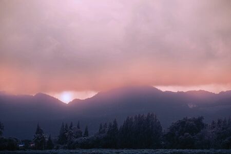 Trees and mountains with the fog of winter.の写真素材