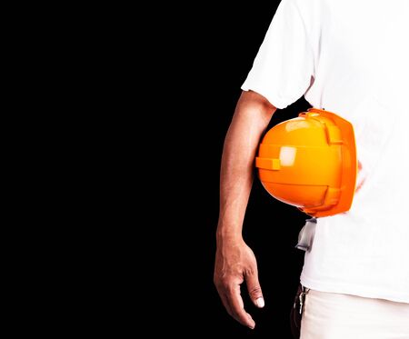 young man with a safety helmet on a black background.の写真素材