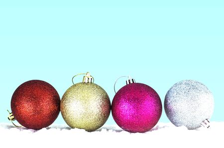 Multicolored balls on the ice with a green background.の写真素材