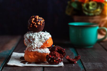 Donuts and chocolate on a wooden floor.の写真素材
