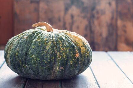 Pumpkin from the garden on the old wooden table.の写真素材
