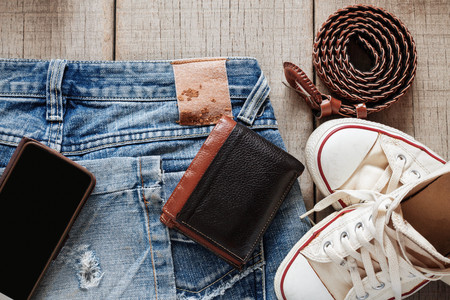Jeans and dress on the old wooden floor.の写真素材