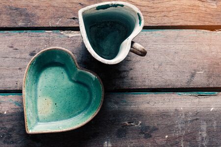 Saucer and cup of coffee on the old wooden floor.の写真素材