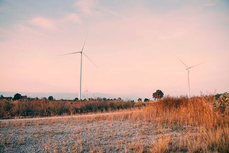 Meadow in the countryside with wind turbines.の写真素材