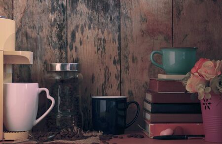 Cup of coffee and old books on table.の写真素材