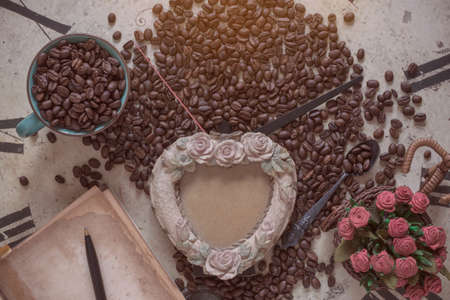 Cup of coffee and picture frame on the old clock.の写真素材