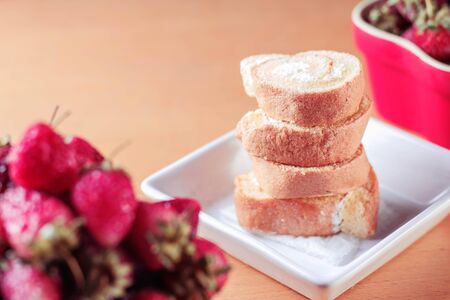 Cake in bowl with strawberry on the table.の写真素材
