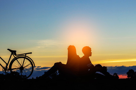 Asian boys and girls with love at the sunset.の写真素材