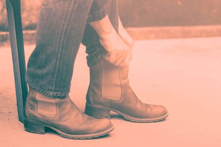 woman wearing of boots on the ground.の写真素材
