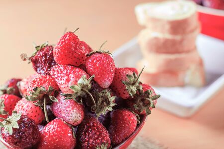 Strawberry on the bowl and cake in the restaurant.