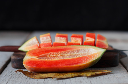 Ripe papaya sliced on wooden floor.の写真素材