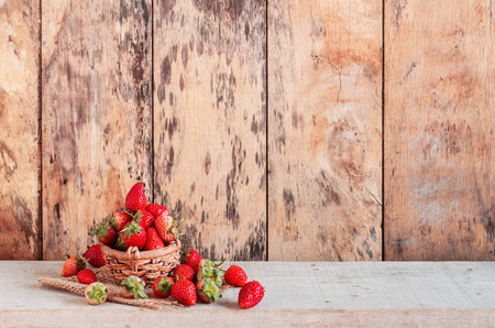 Strawberry in plate on the old wooden.の写真素材