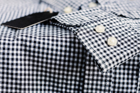 Button on sleeve with black and white of shirt.の写真素材