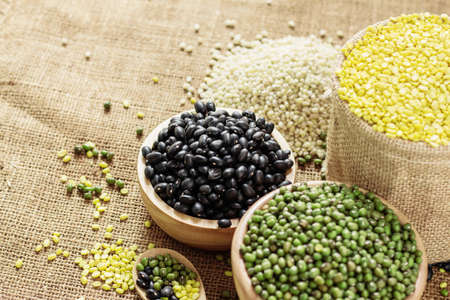 Black bean and other in a bowl on sack.の写真素材