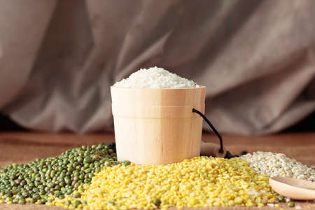 bucket of rice and many nuts on the table top.の写真素材
