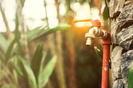 Old faucets with light shining in the garden.