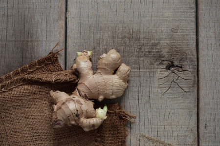 Ginger and sack on the old wooden floor.の写真素材