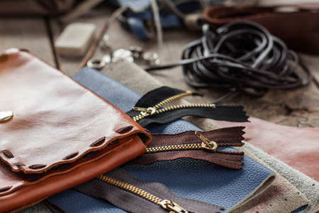 Bags and zip with leather on wooden floor.の写真素材
