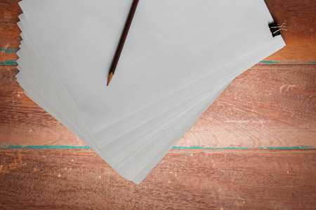 Paper and pencil on the old wooden floor.の写真素材