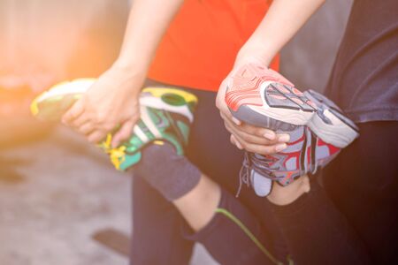 Two women are warming up before playing sports.