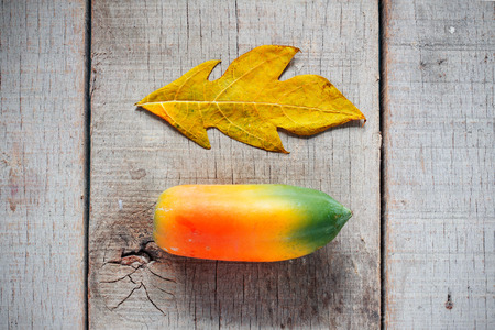 Papaya is ripe and leaves on old plank floor.の写真素材