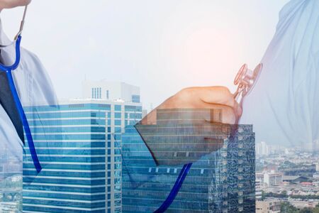 The doctor is using patient monitoring tools with the city society.の写真素材