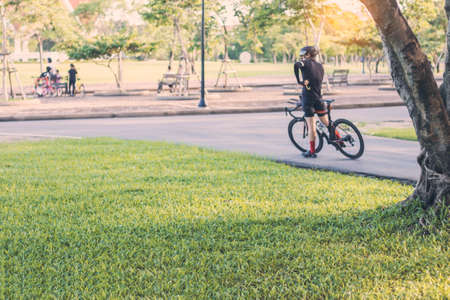 Grass and people with bikes for exercise in the park.の写真素材