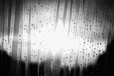 Water droplets on the glass with light and shadow of black and white.の写真素材