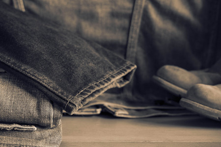 Black of old jeans on wooden floor.の写真素材