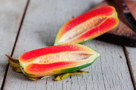 ripe papaya cut in half on the old wooden floor.の写真素材