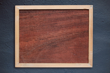 Old wooden frame on a concrete wall.の写真素材